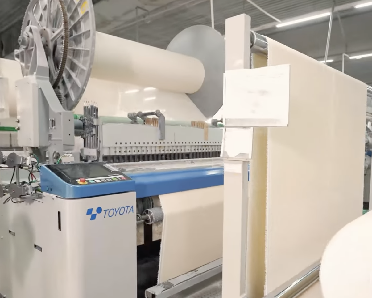 Air jet loom weaving cotton towel fabric in Vietnam manufacturing factory